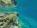 Underwater view showing a snorkeler exploring lively coral reefs near Lombok.