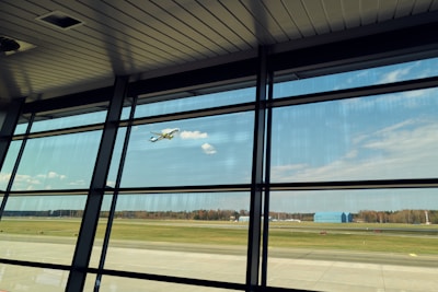 Aerial view of a bustling airport with planes ready for takeoff under clear blue skies.