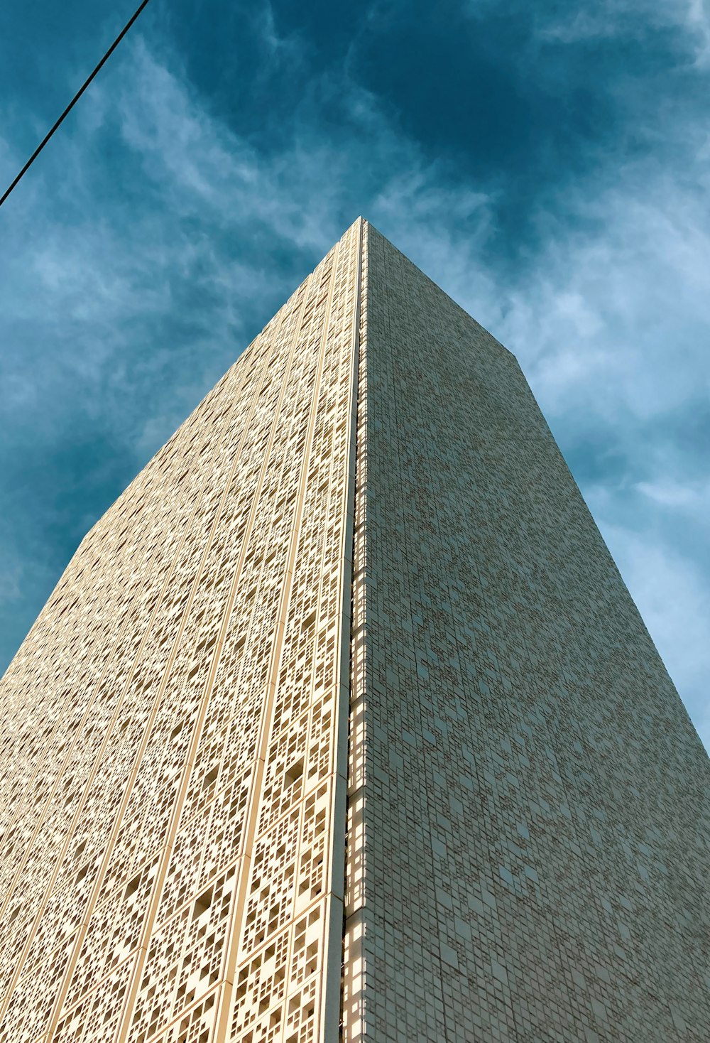 a tall building with a cloudy sky