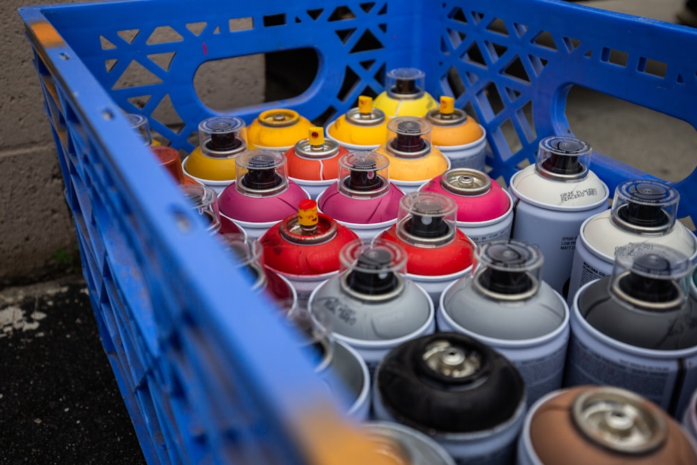 a group of cans in a blue container