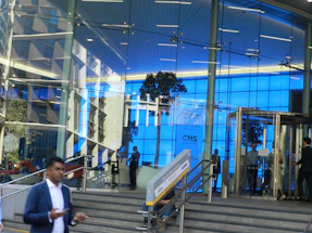 Modern office building entrance with navy and amber accents reflecting a professional consulting firm.