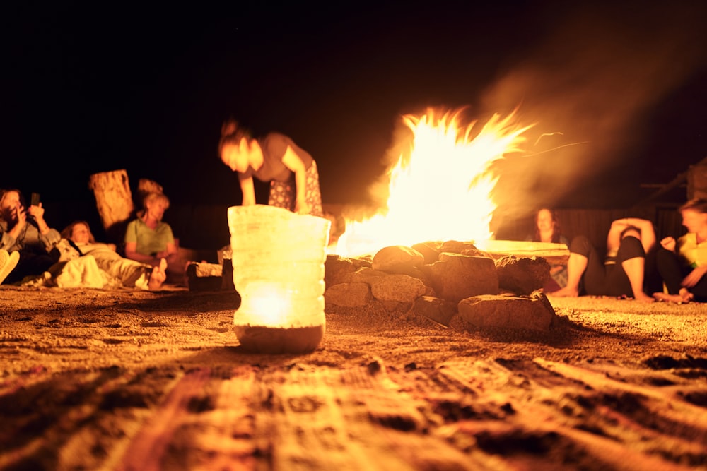 a fire pit with people around it