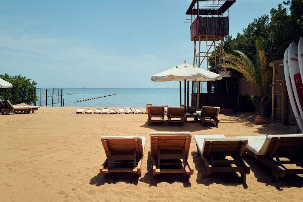 a beach with chairs and umbrellas