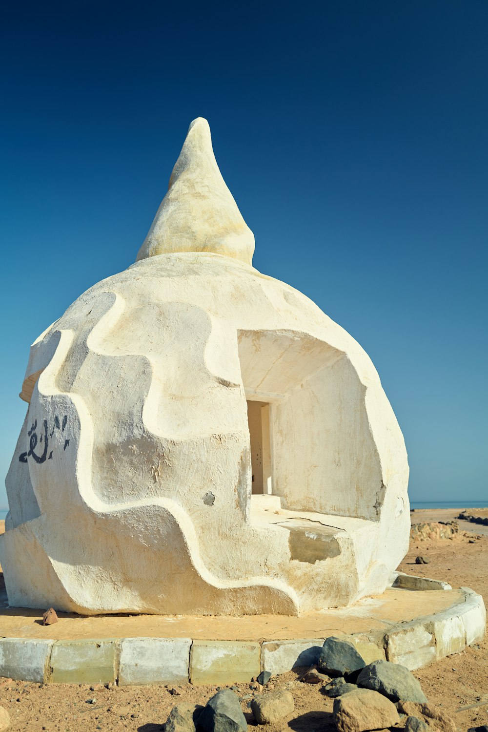 a stone structure with a pyramid on top