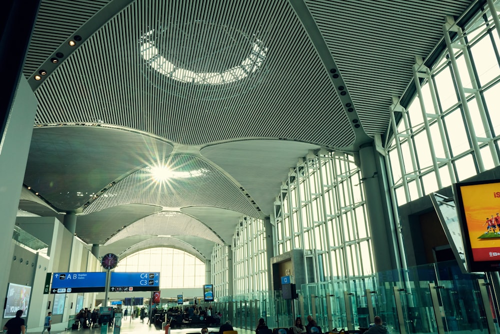 a large room with a large ceiling and many people