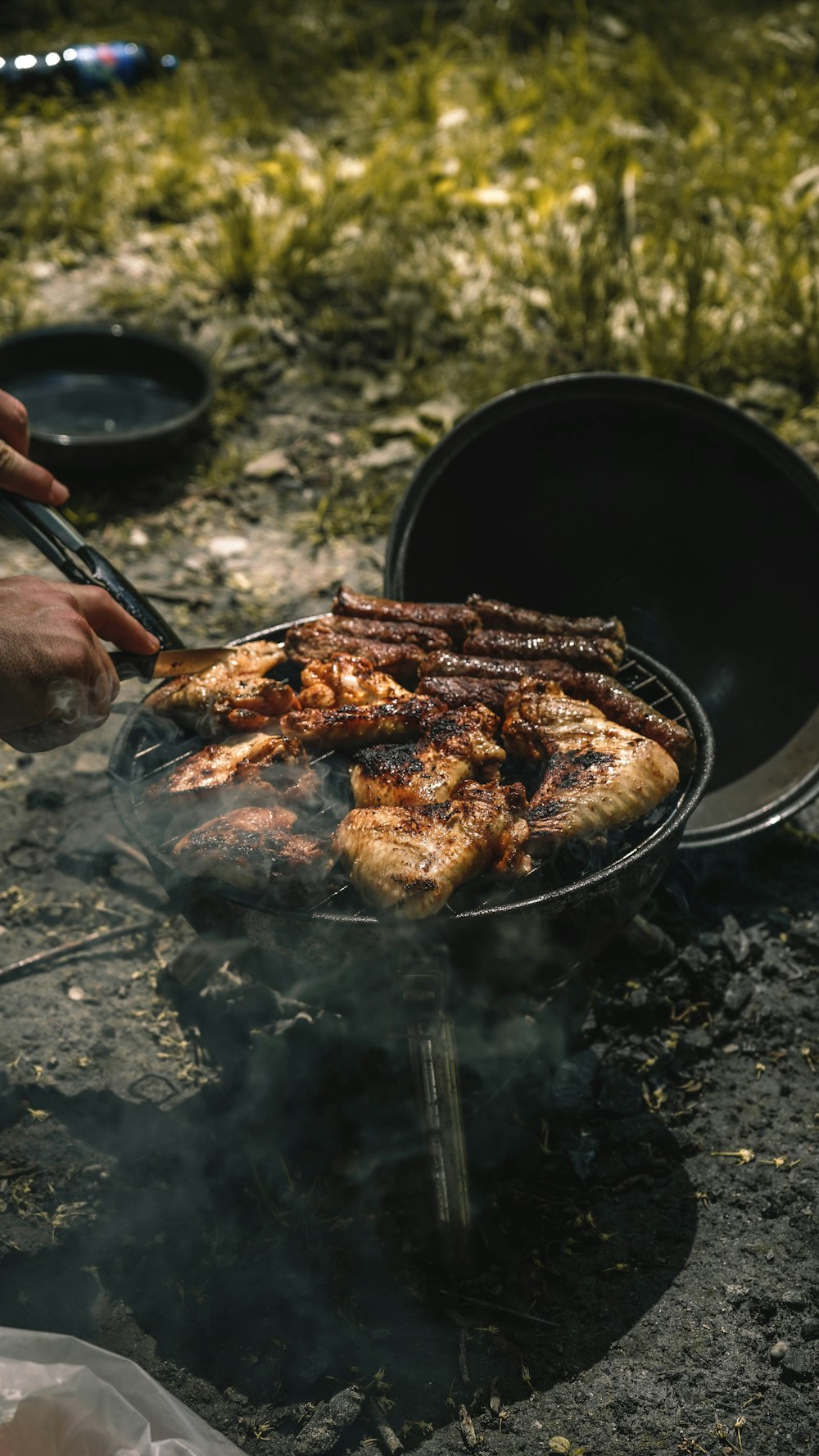 a person grilling a large piece of meat