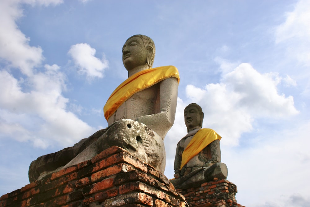 a statue of a man and a woman on a roof