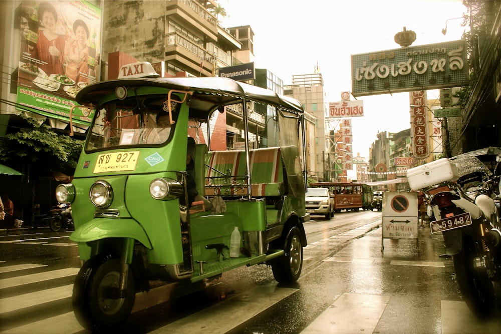 a green bus on the street