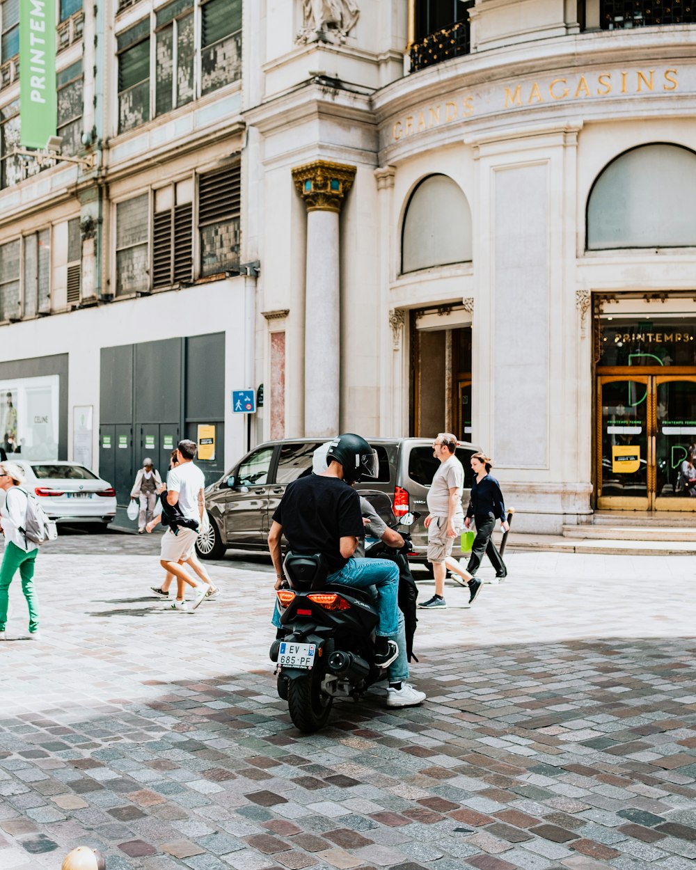 a person on a motorcycle in front of a building