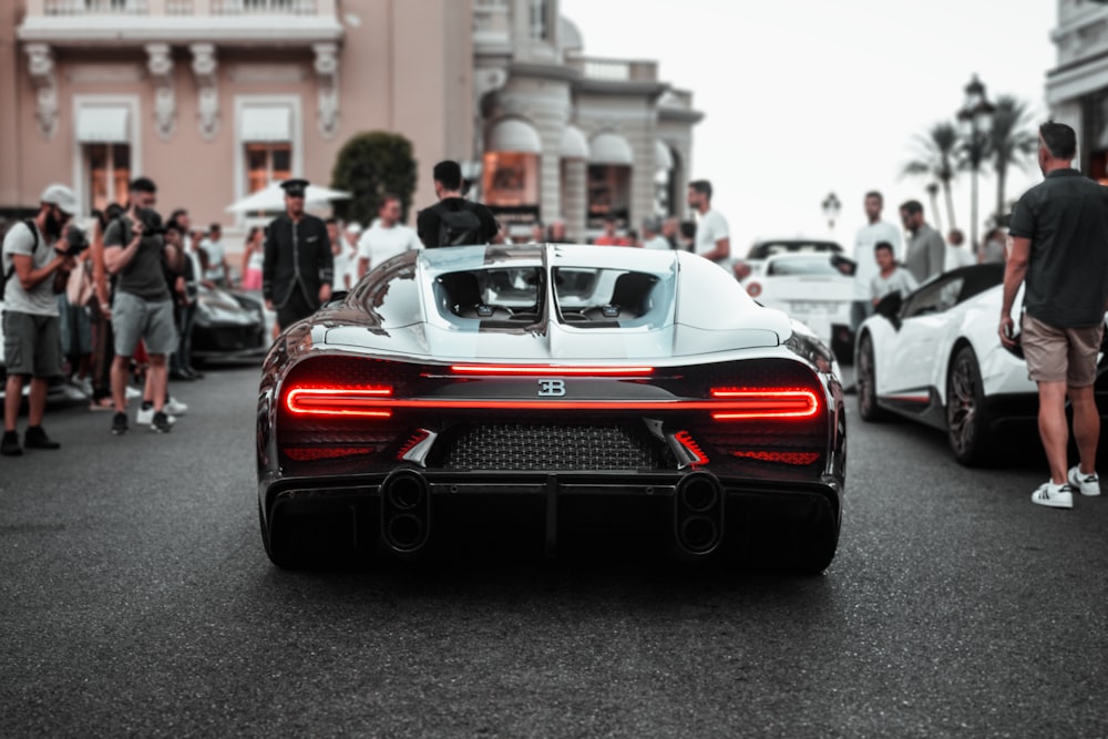 a group of people around a car