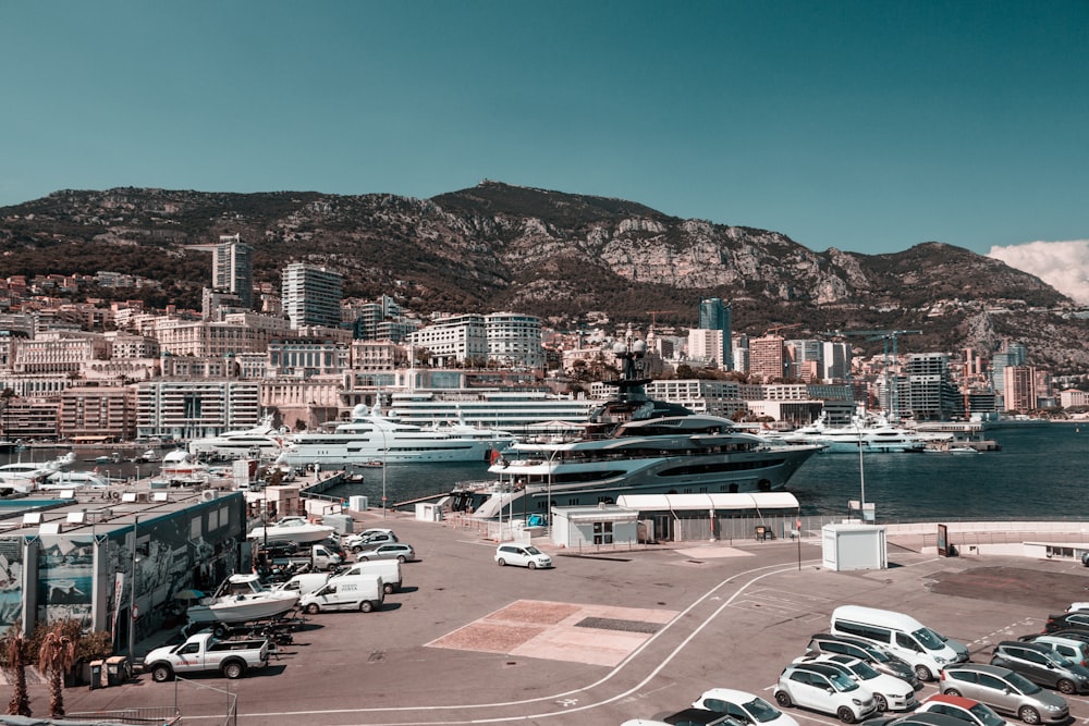 a city with a body of water and a mountain in the background