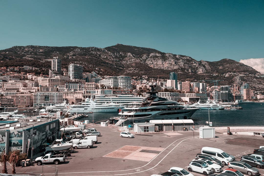 a city with a body of water and a mountain in the background,