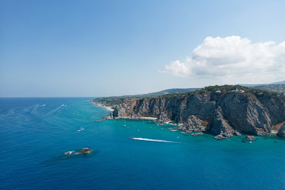 a rocky island with a body of water below