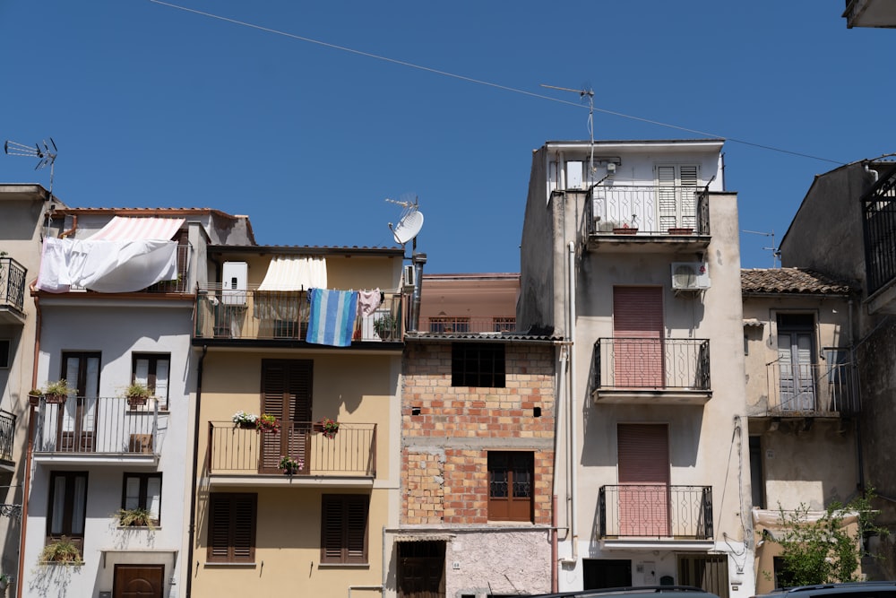 a row of buildings with clothes