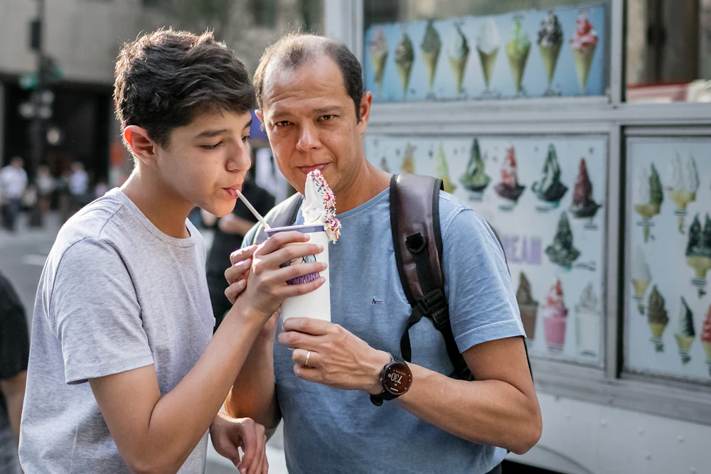 A parent and teenager sharing a treat together