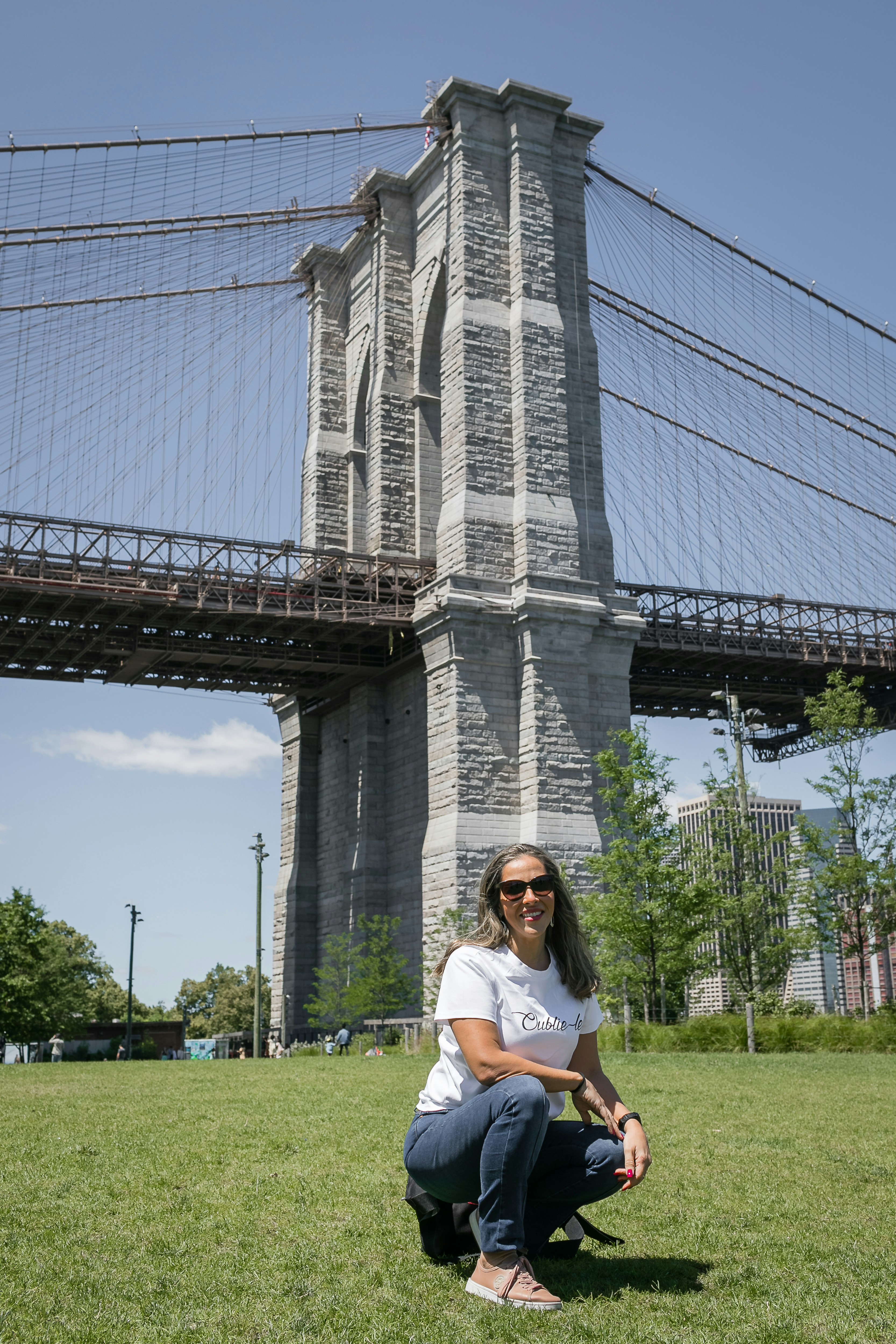 a person sitting on grass in front of a large building
