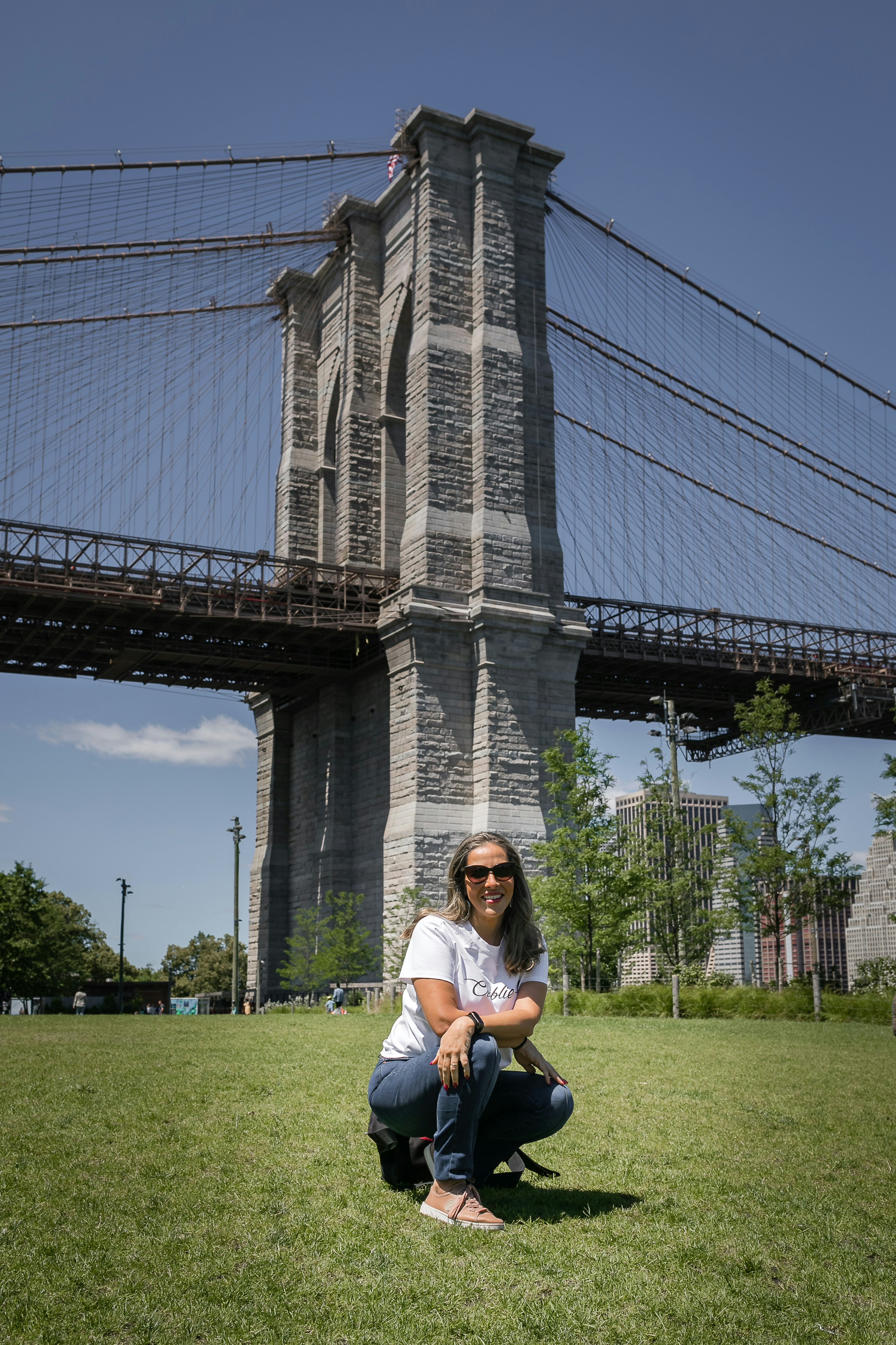 a person sitting on grass in front of a large building