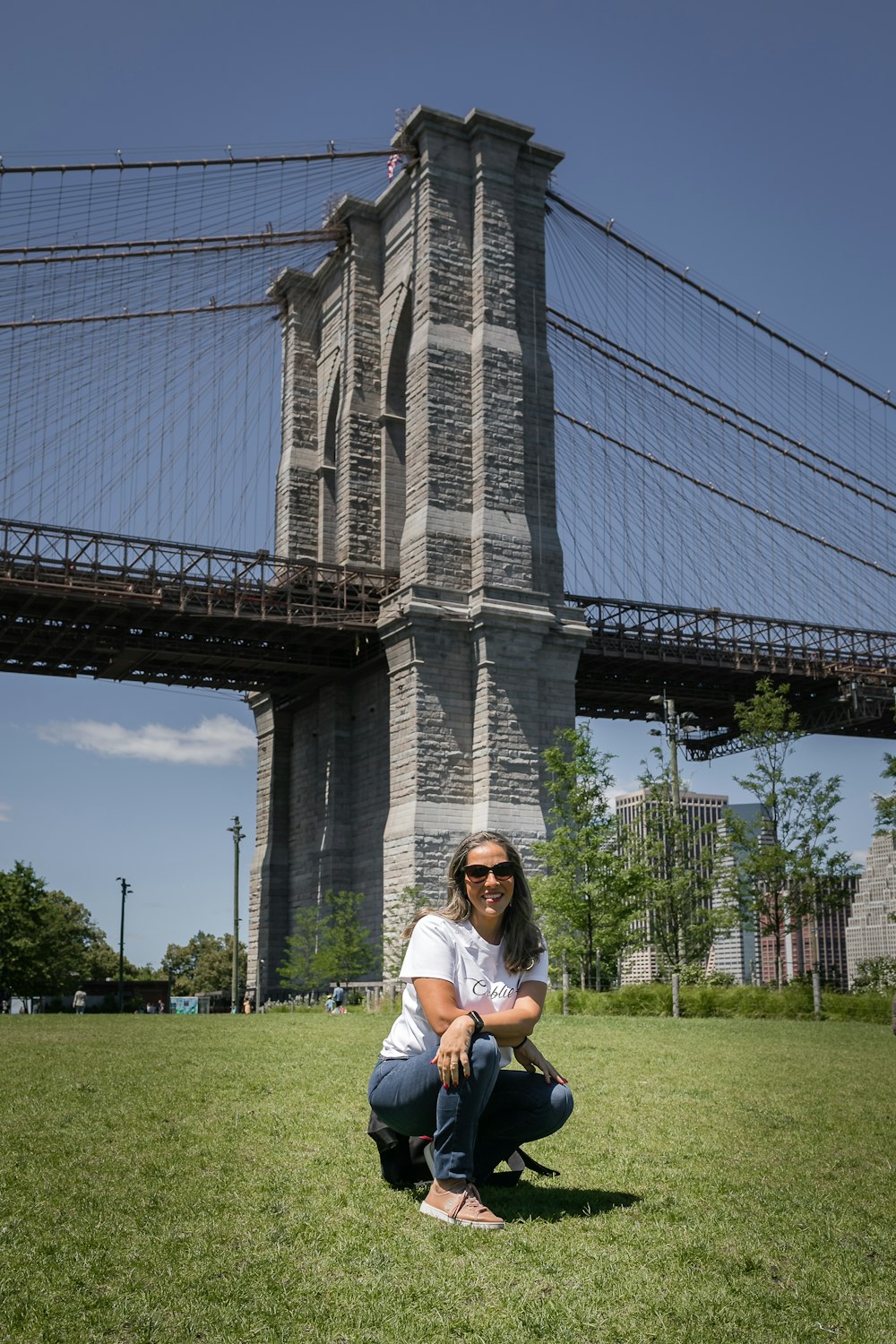 a person sitting on grass in front of a large building