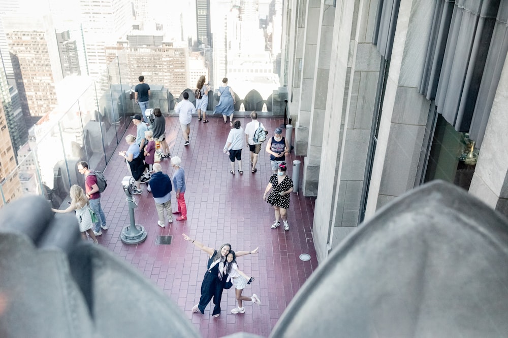 a group of people walking on a sidewalk