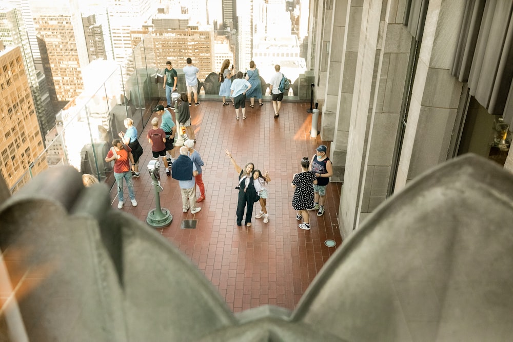 a group of people walking on a sidewalk