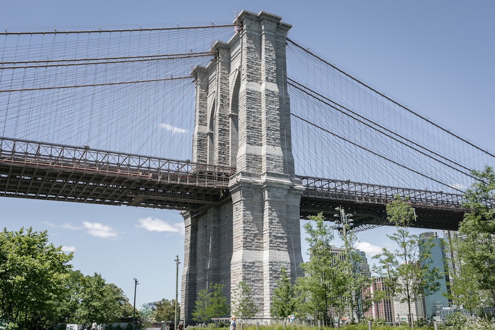 a large bridge with trees and buildings below with George Washington Bridge in the background
