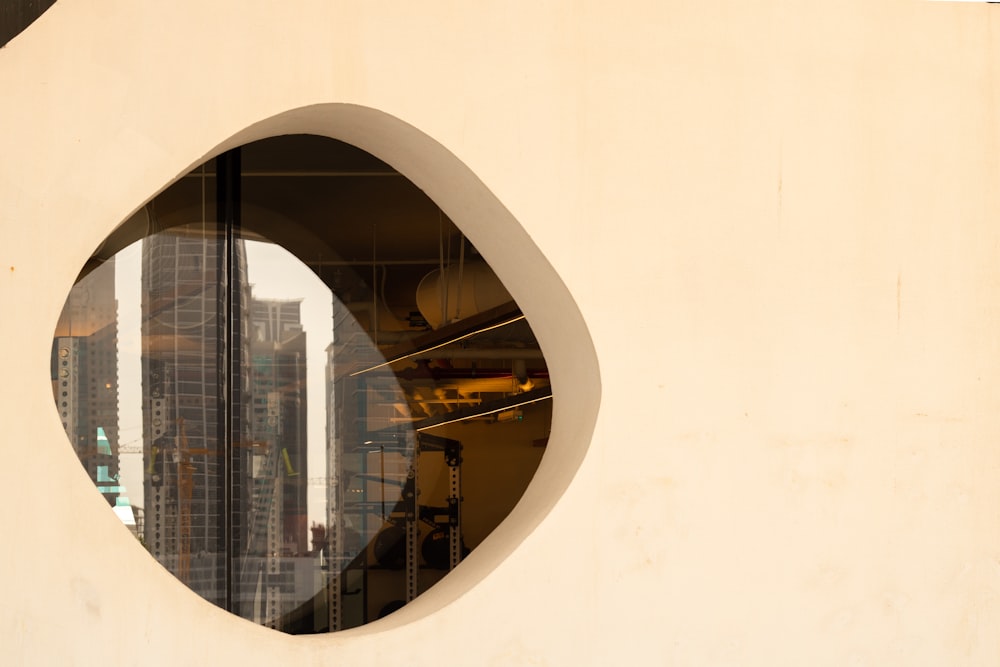 a circular mirror with a reflection of a building in it