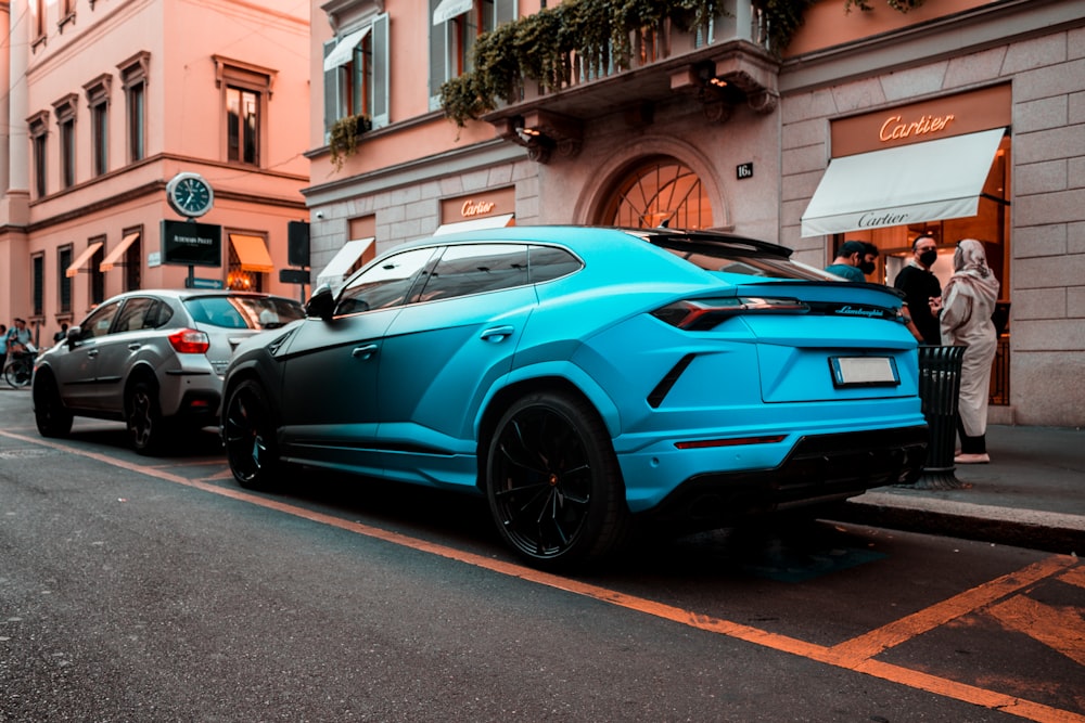 a blue car parked on the side of a street