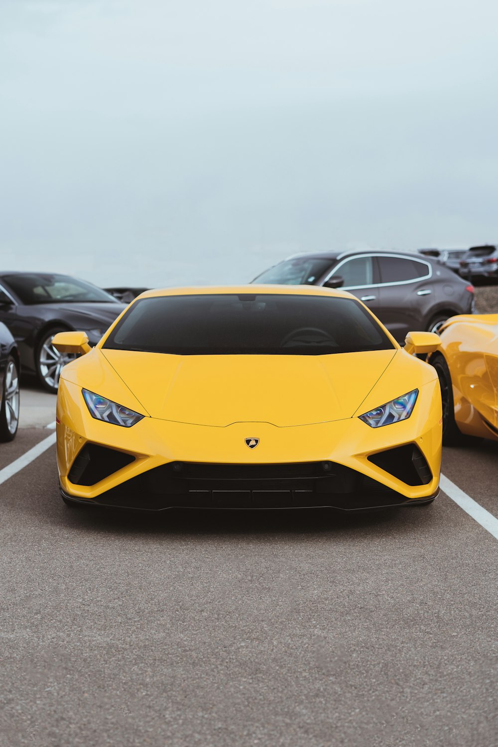 a yellow sports car parked in a parking lot