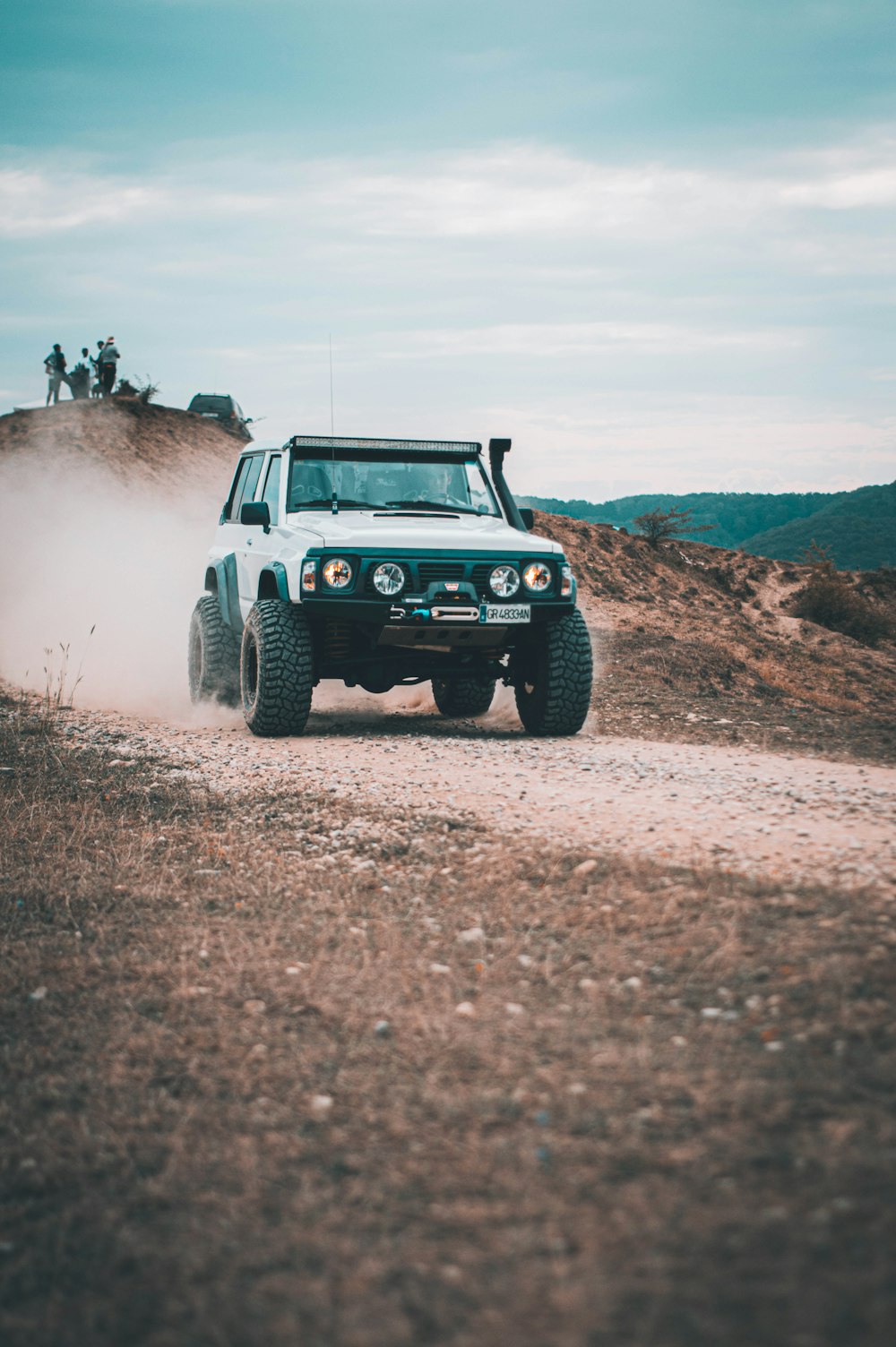 a car driving on a dirt road