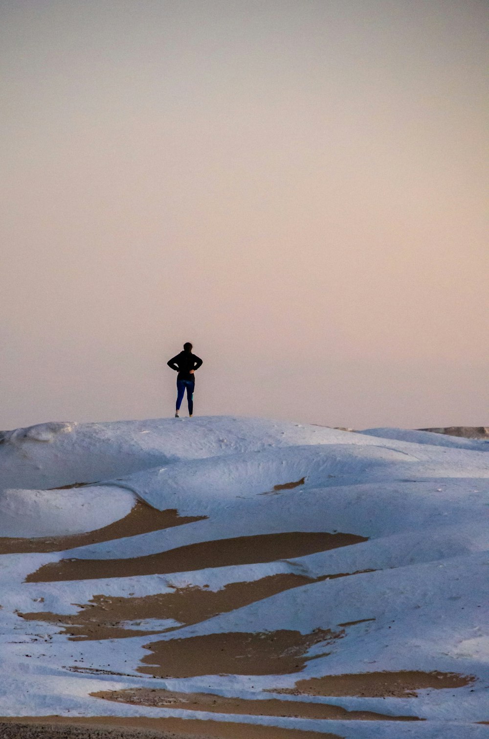 a person standing on a snowy hill