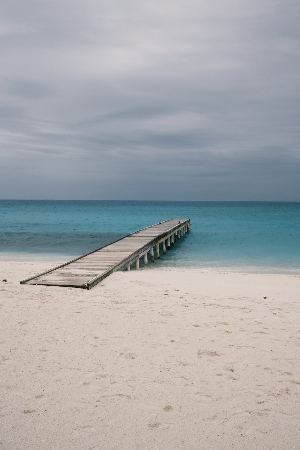 a wooden dock on a beach