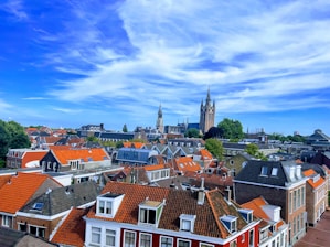 A scenic European cityscape with iconic landmarks under a bright sky.