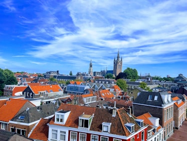 A scenic European cityscape with iconic landmarks under a bright sky.