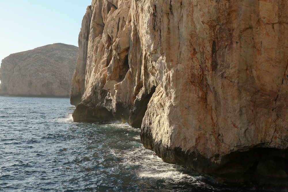 a cliff next to the water