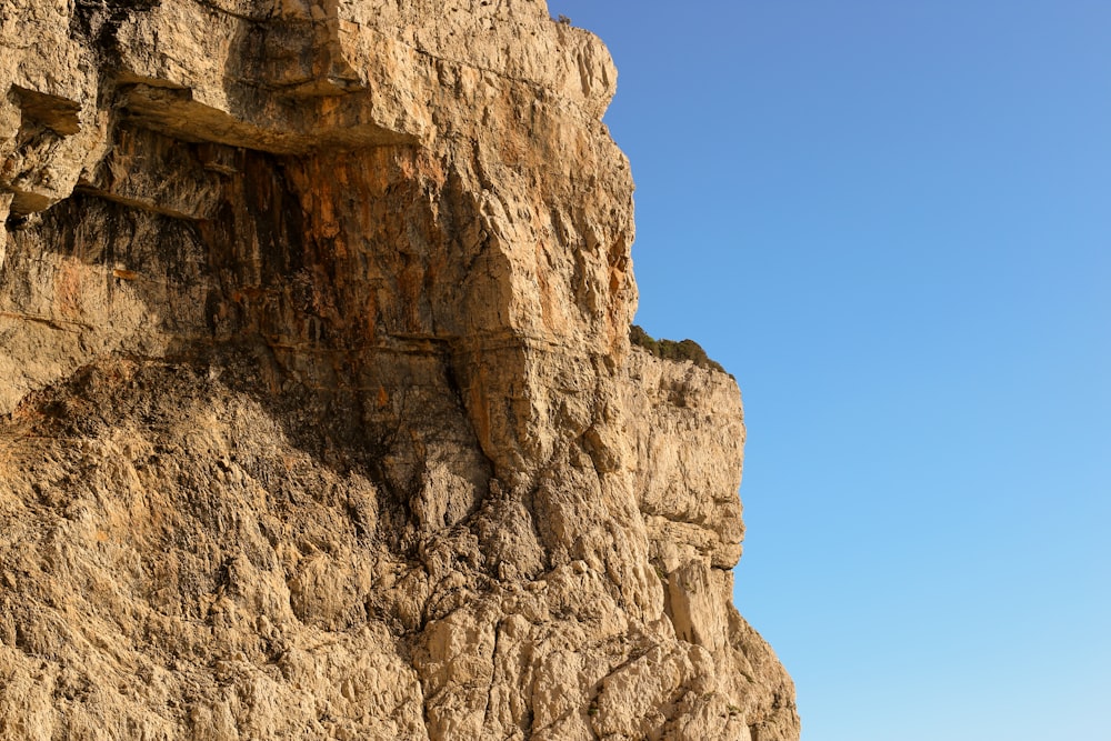 a cliff with a blue sky