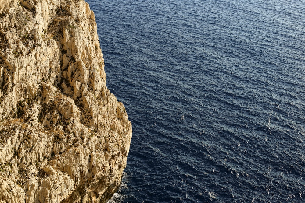 a cliff next to the water