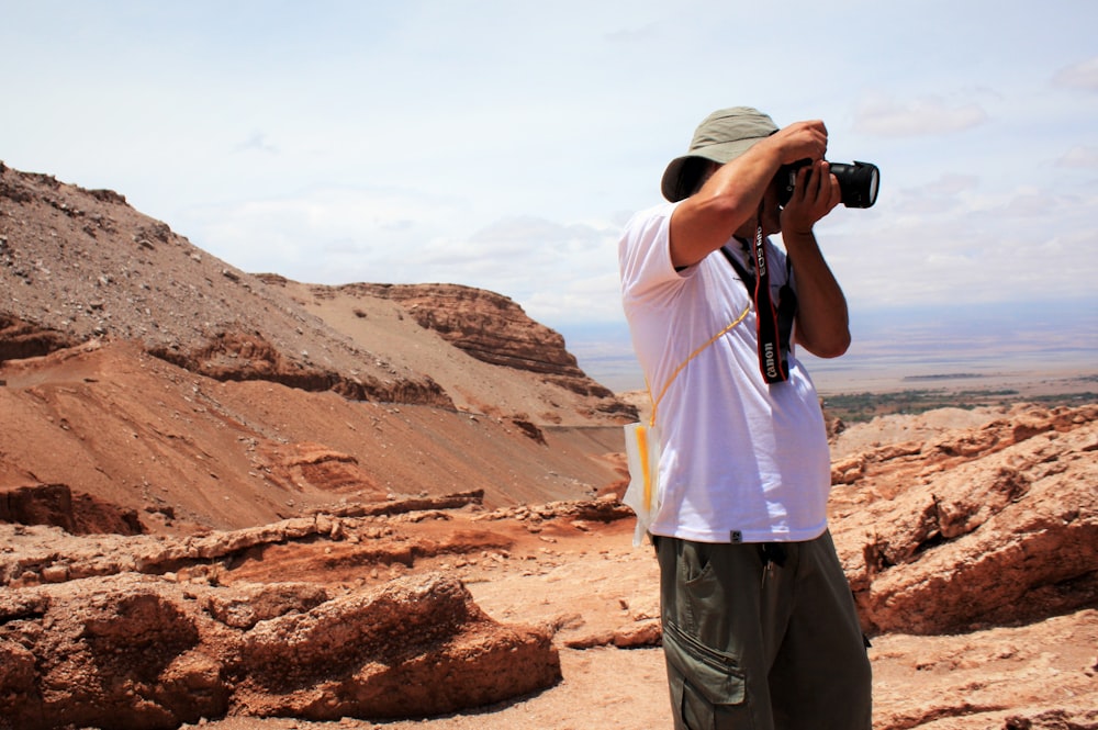 a person taking a picture of a canyon