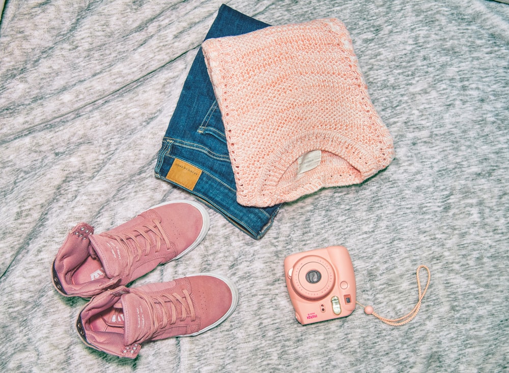 a cell phone and a pair of shoes on a carpet