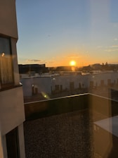 Rooftop view of Midtown Manhattan skyline during sunset.