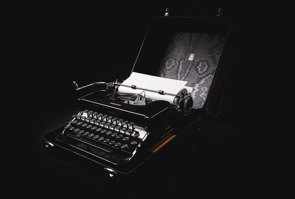 a black and white photo of a typewriter with a black background