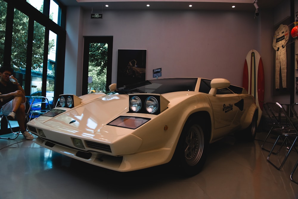 a white sports car in a room