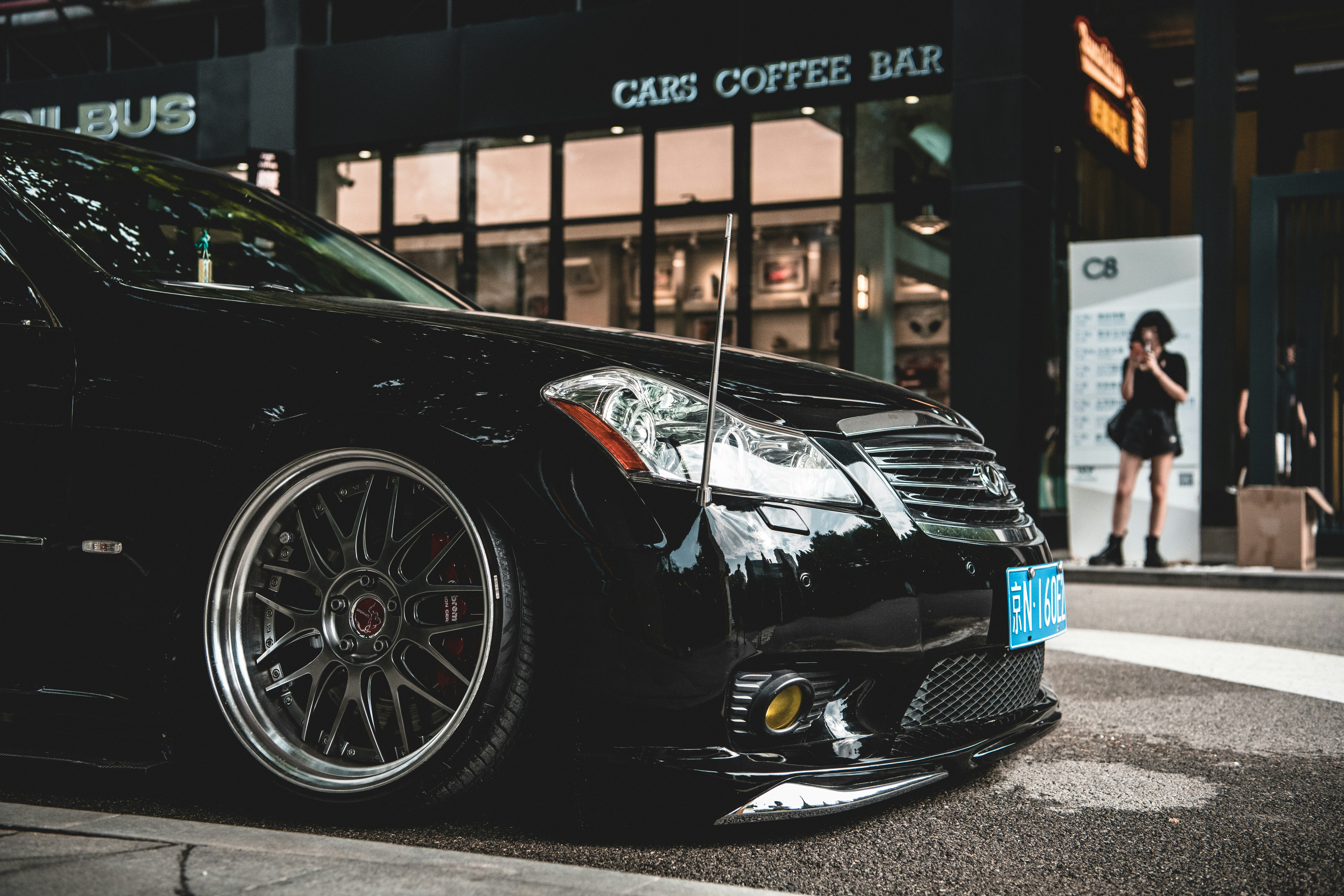 a black car parked outside a building