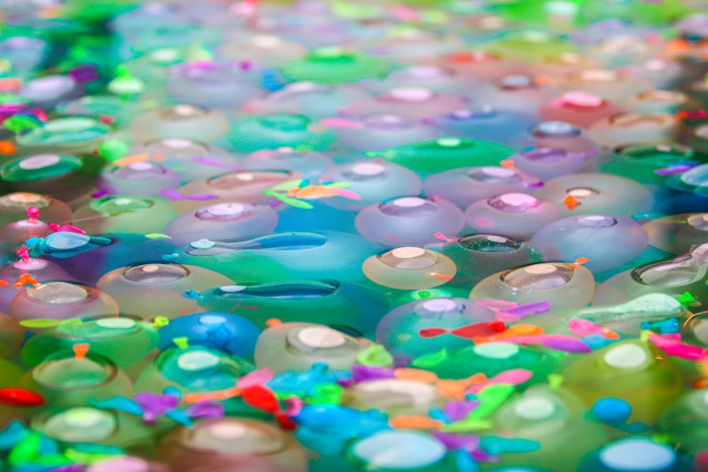 a close up of a pile of colorful jellyfish