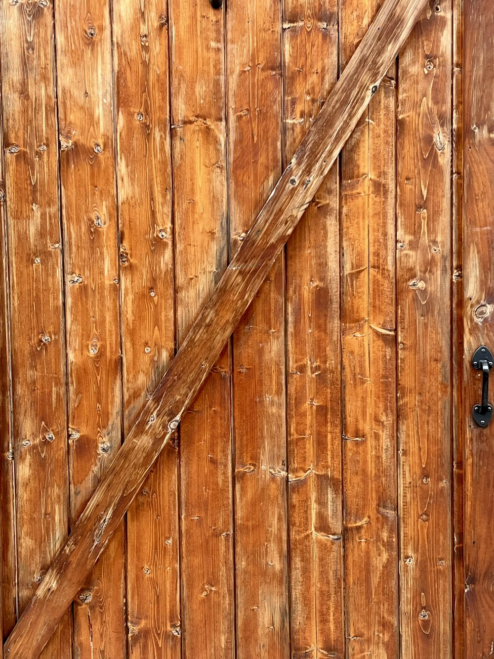 a wood door with a metal handle