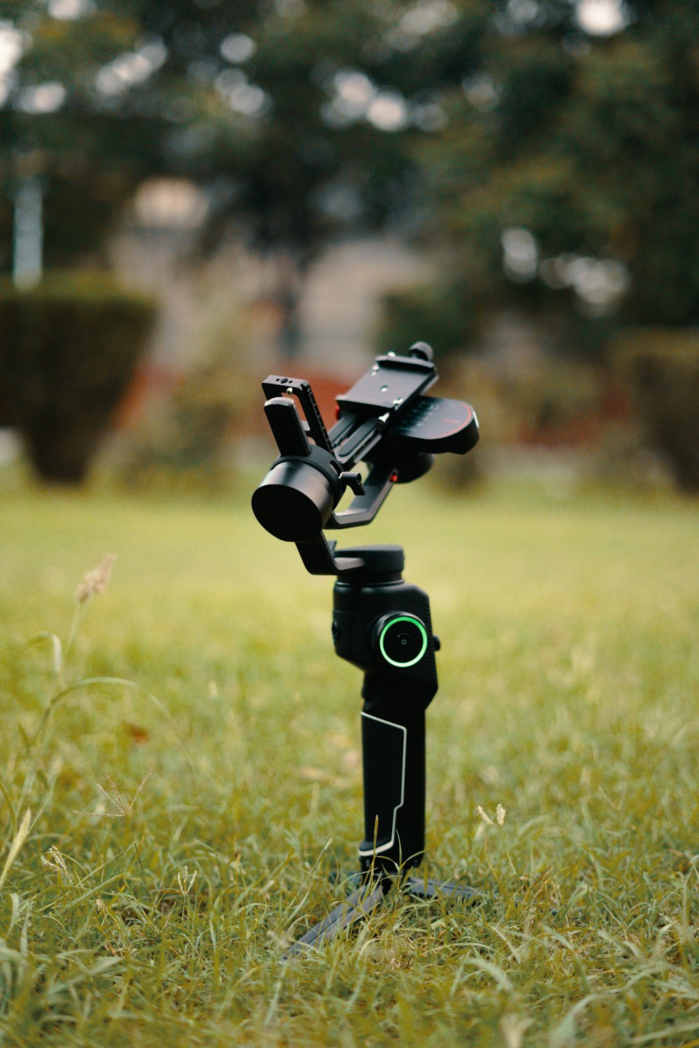 a camera on a tripod in a grassy field