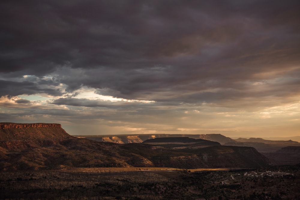 a landscape with hills and clouds