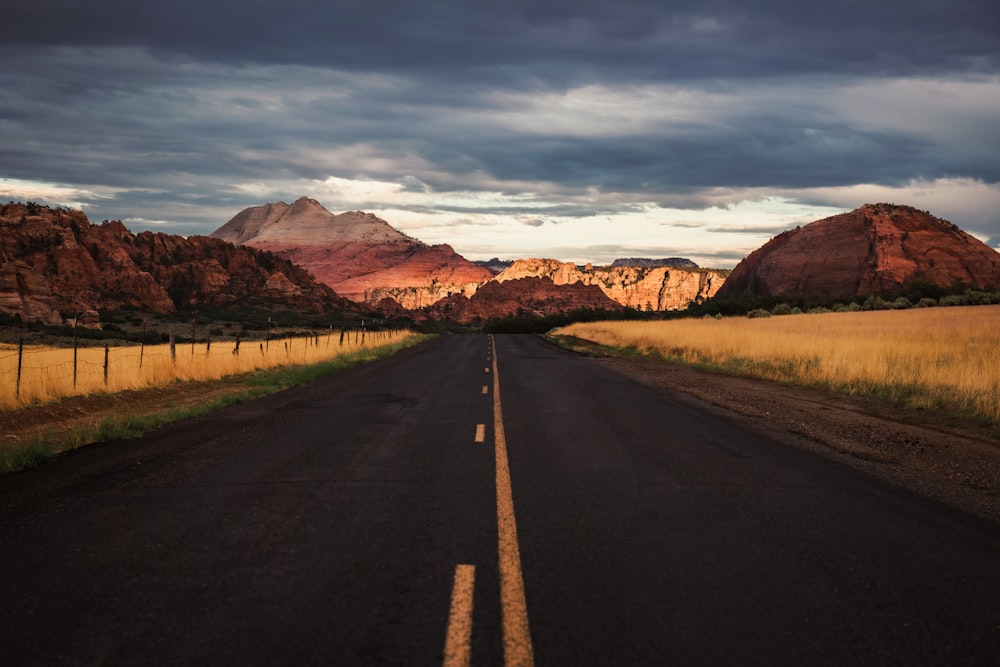 a road with mountains in the background