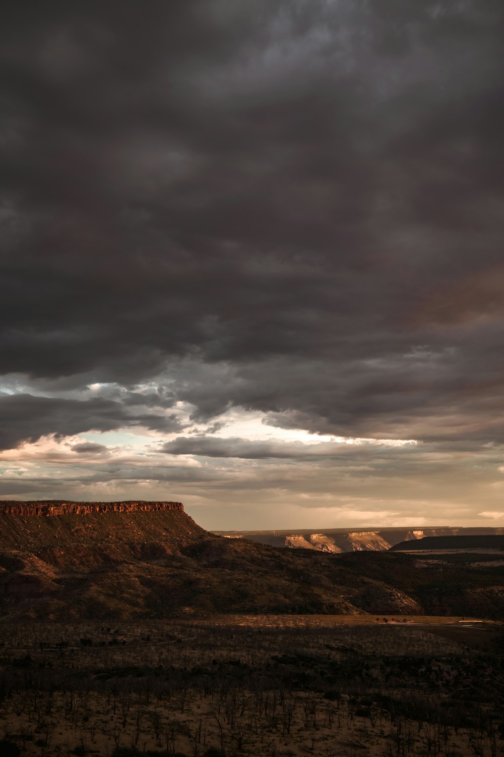 a landscape with hills and clouds