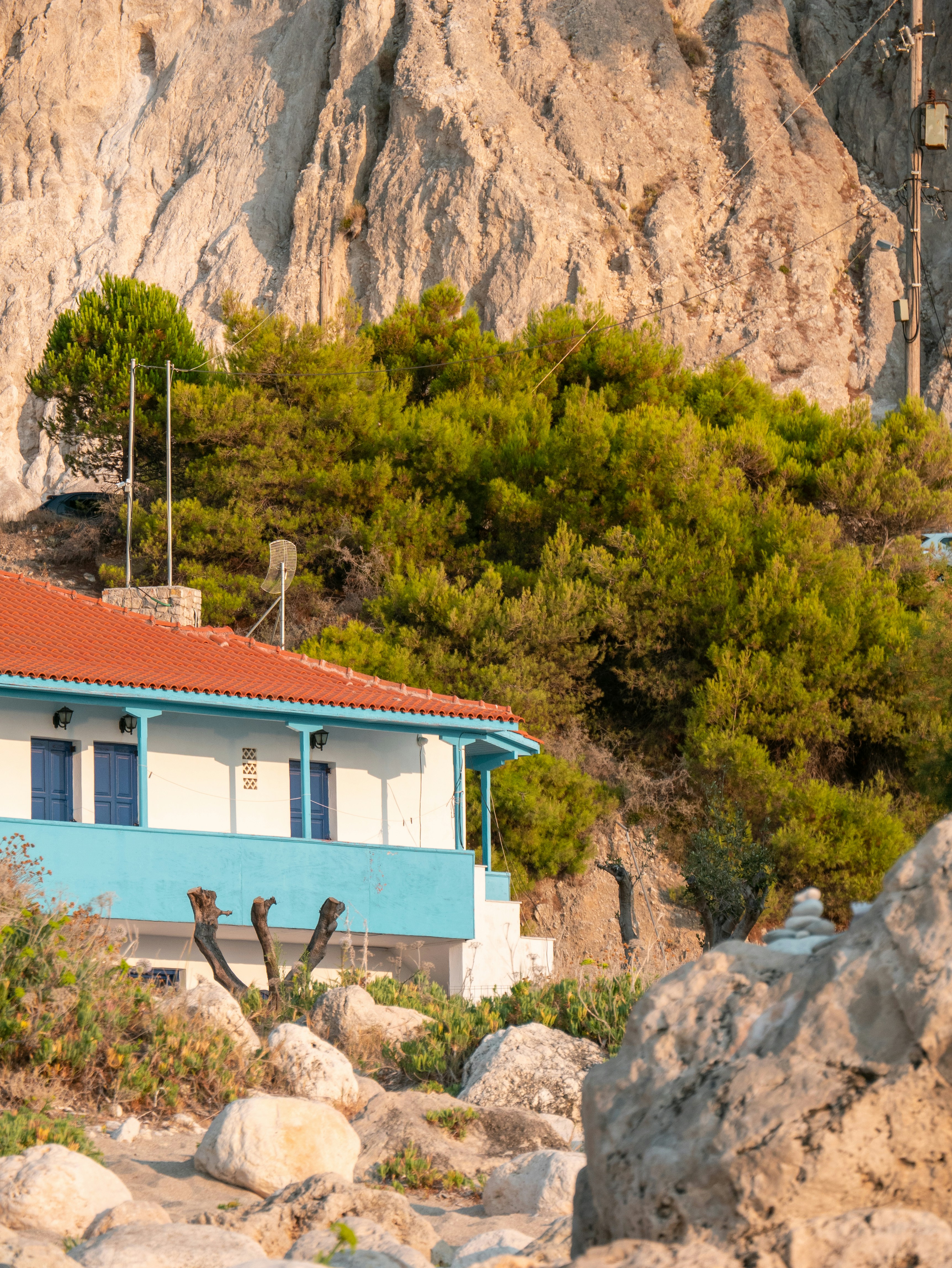 a house in front of a rocky cliff