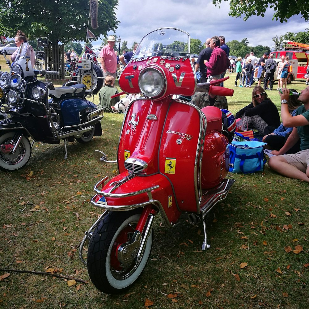 a red motorcycle parked on grass